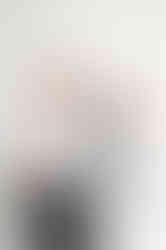 Claire smiling beside a mannequin in her Liverpool wedding alterations studio during her wedding industry brand shoot.