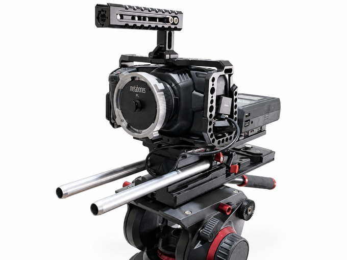 Side view of Blackmagic Design Pocket Cinema Camera 4K with cage, rods and power against white background