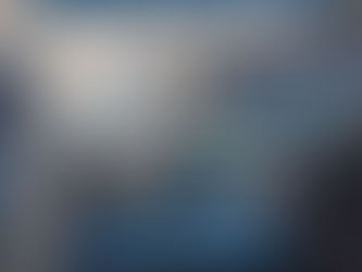 Airplane seats with blue cushions, screen, pillows, and windows showing sky. Text: Breeze Airways Seat Upgrade. Contact info provided.