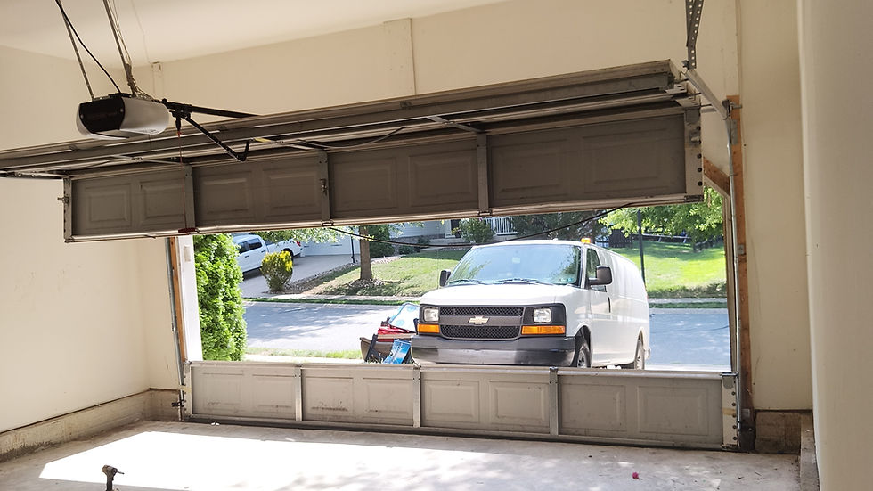 Broken garage door needing emergency door repair.