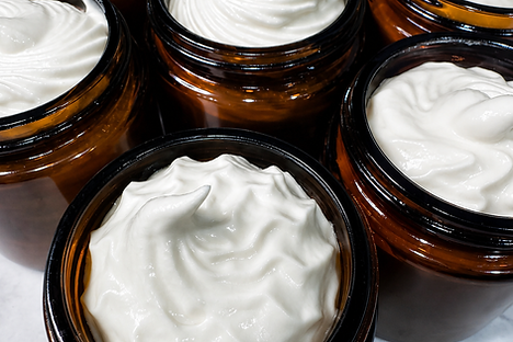 A jar of whipped tallow herbal face cream from Soul Aurum, showcasing its smooth and creamy texture