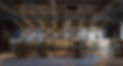 Upscale bar and restaurant interior, tables and chairs, decorative lighting fixtures present.
