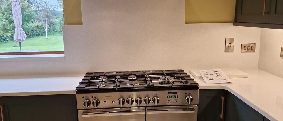 Stainless steel range cooker and extractor hood in a modern kitchen