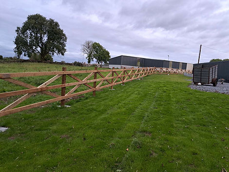 New timber fence installation, green grassy field