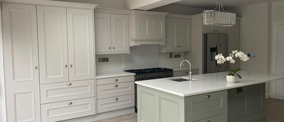 Elegant cream and green kitchen island with fitted units