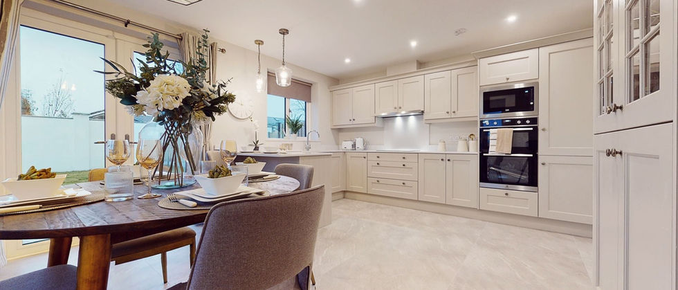 Modern kitchen diner with wooden table and cream units