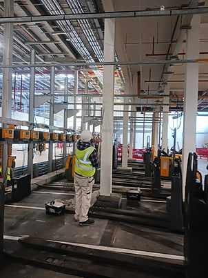 Painting contractor inspecting a column in a warehouse
