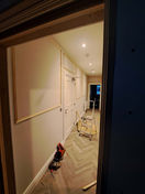 Hallway renovation: elegant paneling, herringbone floors