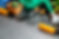 Gardening tools, potted plant, and watering can on stone surface