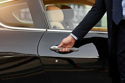 Hand opening a black car door P O’Driscoll & Sons Limousine Service
