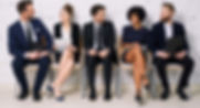 Five professionals sitting and talking