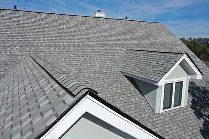 Gray shingles on a house roof, sunlight, and a sunny day. High View Roofing & Guttering