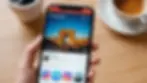 Eye-level view of a smartphone displaying Instagram's new layout