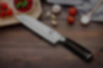 A close-up of a kitchen knife with a sharp blade