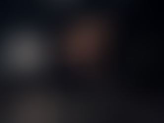 A woman working out on a weight bench in a dark gym wearing One Temple Fitness black leggings with a cross on the hip