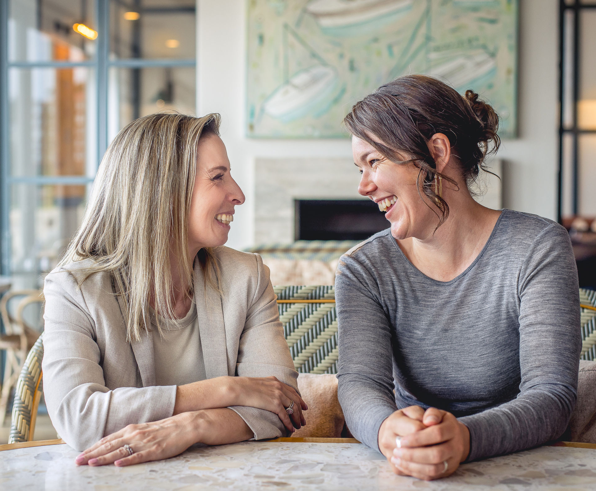 Two women branding shoot for your collaboration in fertility business. At Bathers at a table having a chat. Personal branding photo shoot Suzanne Stevenson Photography