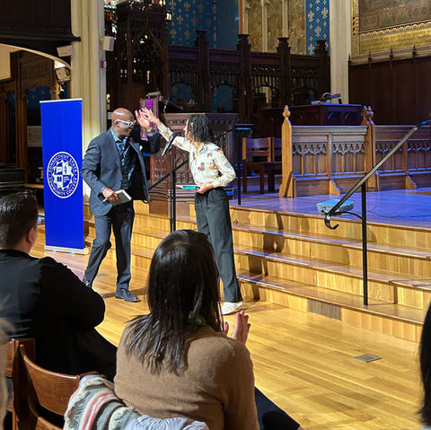 Man high fives woman after she shares her work.