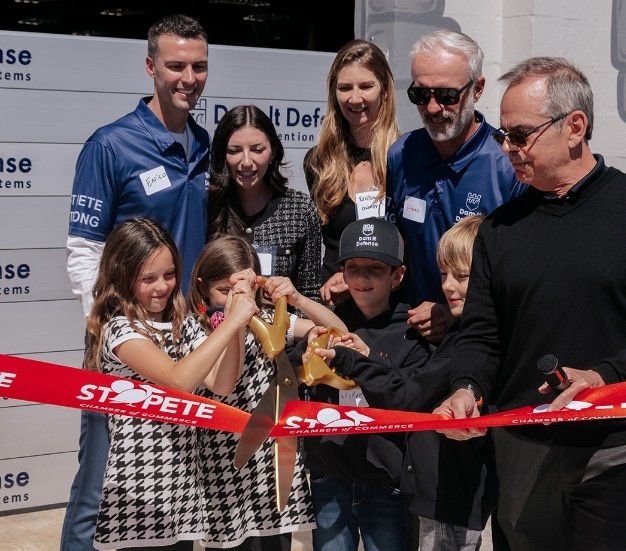 From back left: Enrico Palmerino, co-founder of Dam It Defense; Carlie Palmerino; Kristin Fustar; Danny Fustar, co-founder of Dam It Defense; their children; and Christ Steinocher (right), CEO of the St. Petersburg Area Chamber of Commerce. Photo by Kayla Avirett. 