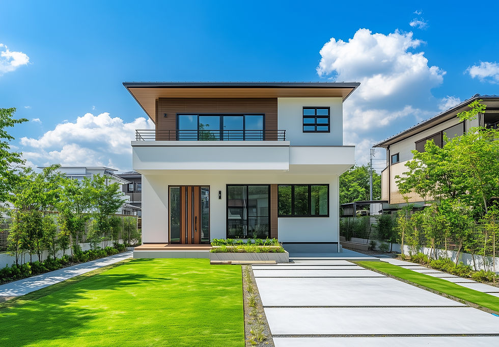 Contemporary white and brown house, green lawn, concrete driveway, blue sky.