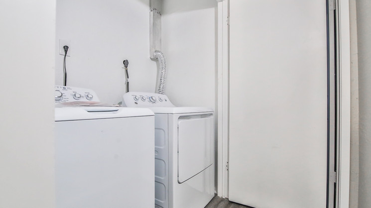 Full-size washer and dryer laundry area inside an apartment at Lubbock Heights Apartments in Lubbock, Texas.