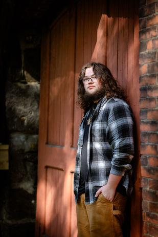 senior portrait, plaid shirt, red door, dappled sunshine