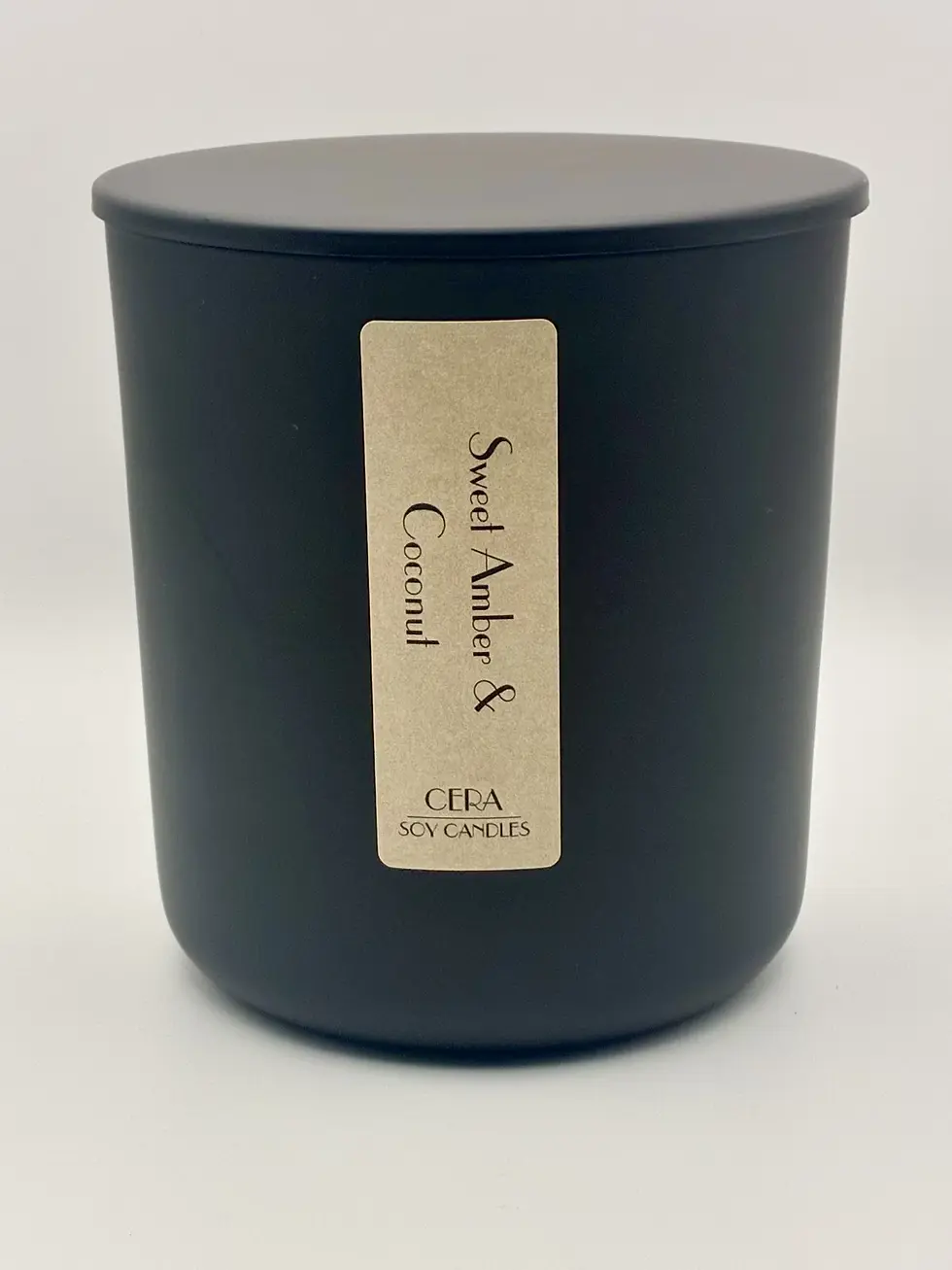 Sweet Amber & Coconut 8 oz natural soy candle in a matte black jar with matching lid