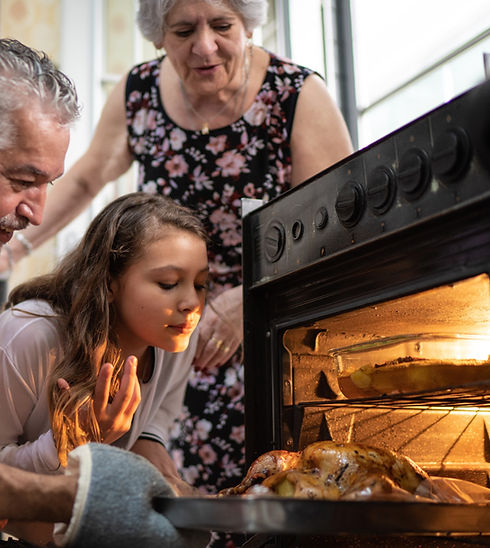 Family gathered round an oven