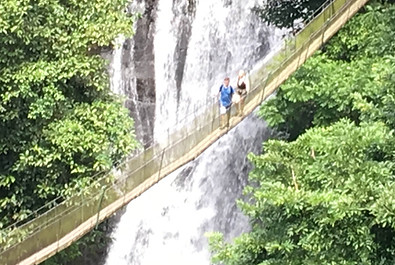 a hanging bridge over a waterfall