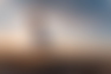 Woman in yoga pose at sunrise on the beach