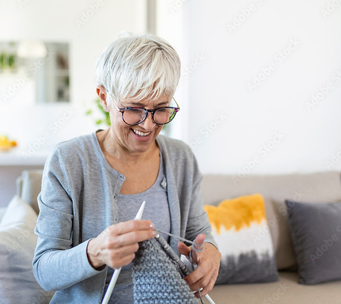 Woman happily knitting