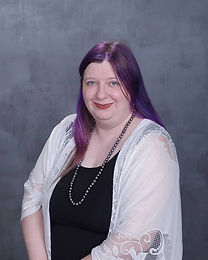 Image of a smiling woman with long purple hair.