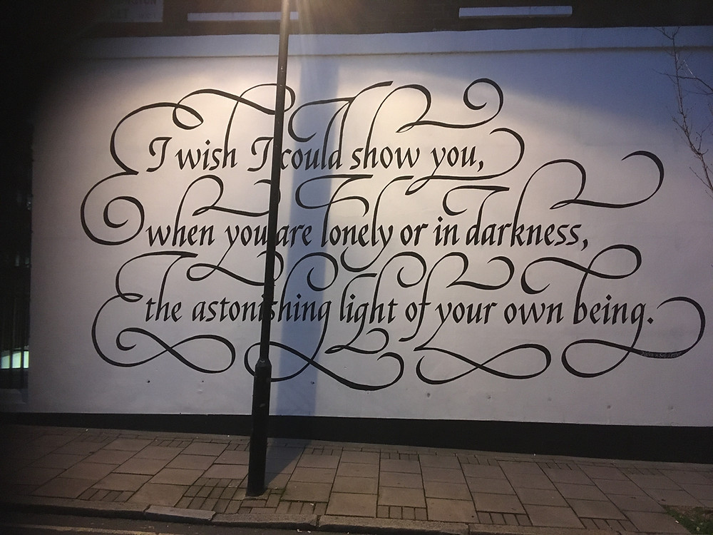 A wall with a painted poem