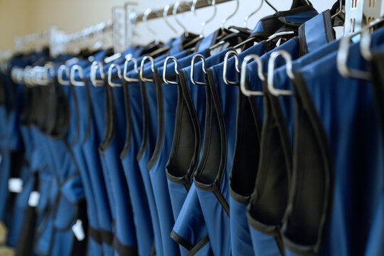 Close-up view of lead aprons hanging in a storage room