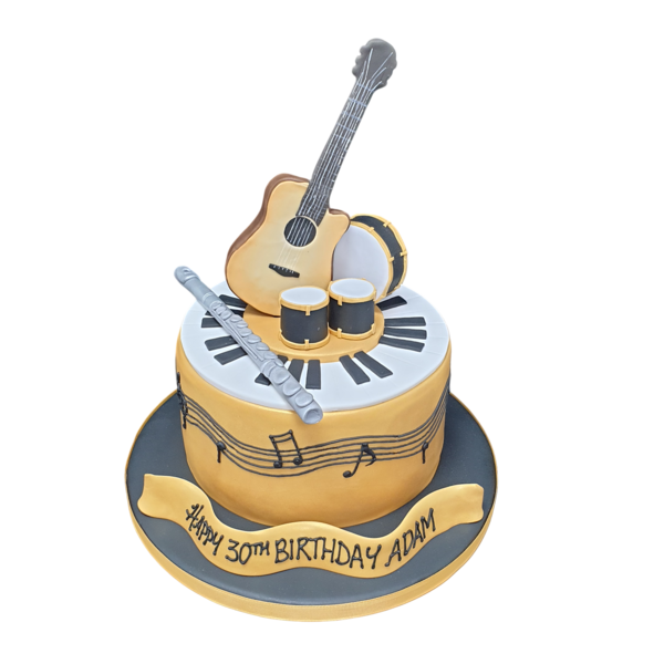 A beautifully decorated cake featuring miniature musical instruments on top, perfect for music lovers and special occasions.