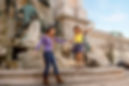 mom and daughter play by fountain in world travel adventures by disney