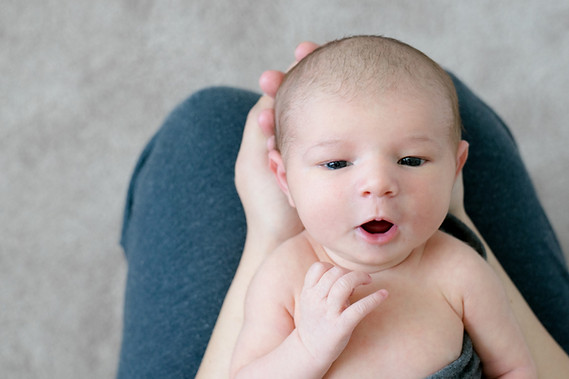 newborn held in mom's lap