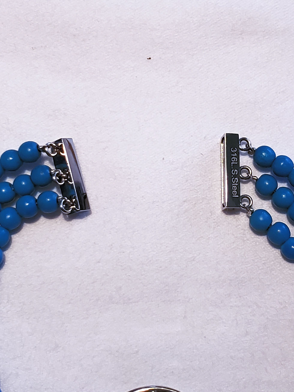 Thumbnail: Sleeping Beauty Turquoise colored Howlite triple strand bracelet magnetic clasp