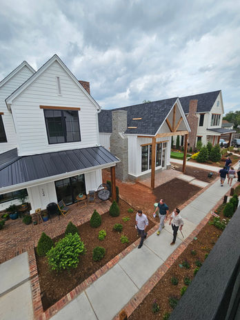 A photo from a balcony of three two-story homes in a row