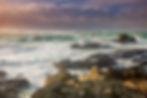 A storm rages at Pleinmont Point, Guernsey with Hanois Lighthouse in the distance
