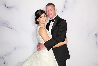 Smiling bride and groom embracing