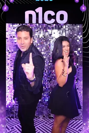 Man and woman posing with 'n1co 2025' and 'we are unique'