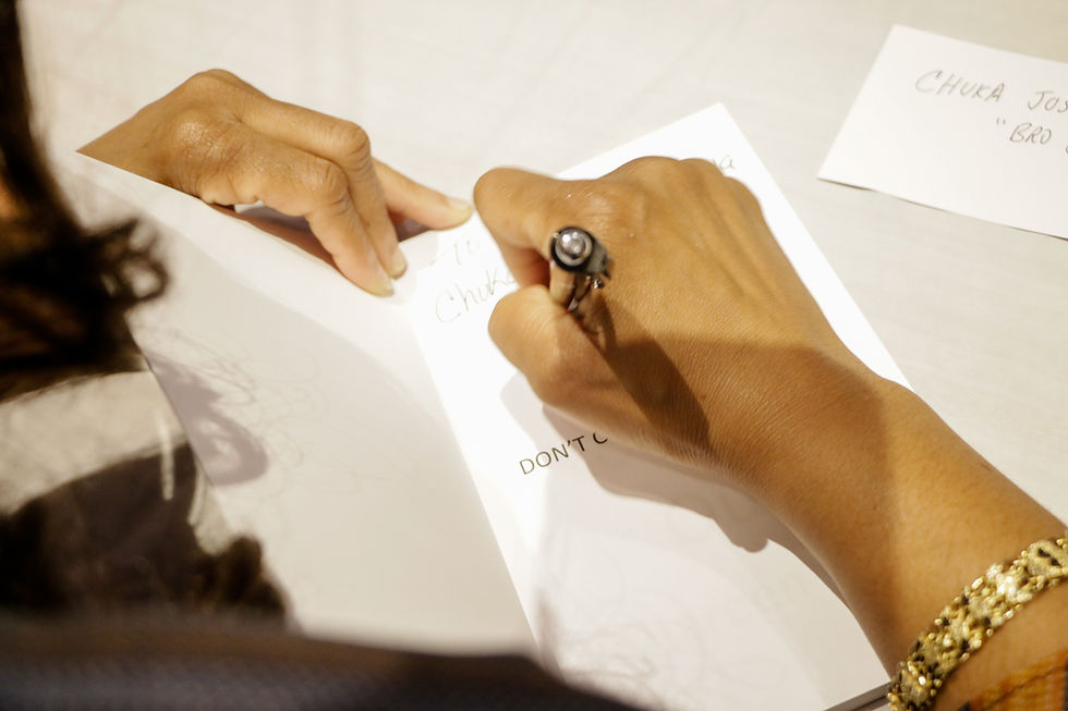 Hands of the writer signing her book