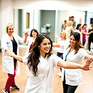 A group of beautiful and smiling Healthcare workers demonstrate Salsa & Bachata steps at F