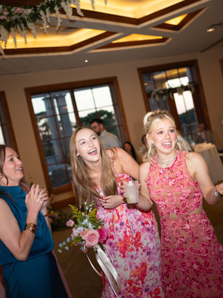 Bouquet toss at whimsical spring wedding in Hot Springs, AR