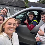 A man hanging out of a van during a Kilkenny scavenger hunt