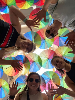 Team building activity with members waving in front of coloured umbrellas in Dublin City