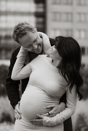Black and white portrait of an expecting couple