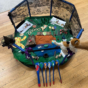 Octagonal play mat with toy animals and colorful spoons