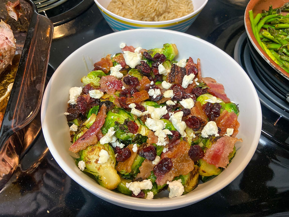 Bowl of salad with brussel sprouts, bacon, raisins, and feta
