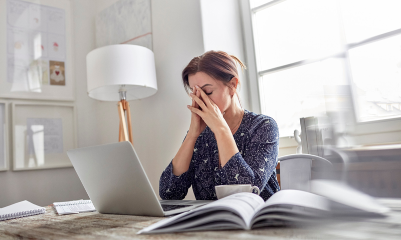 Woman stressed in front of laptop